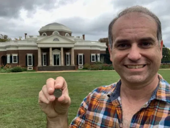 Here I am holding a Jefferson nickel showing Monticello in front of the actual Monticello in Virginia.
