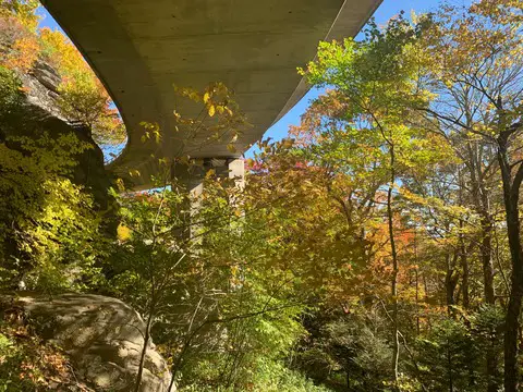 Walking the Tanawha Trail under the Linn Cove Viaduct along the Blue Ridge Parkway in North Carolina during peak fall colors! 