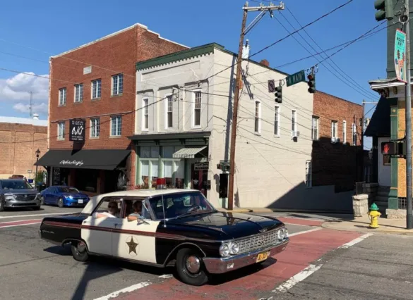A squad car similar to that used by Sheriff Andy Taylor (played by Andy Griffith) in The Andy Griffith Show gives tours of Mt. Airy, the North Carolina town that inspired the fictional setting of Mayberry in the 1960s show.