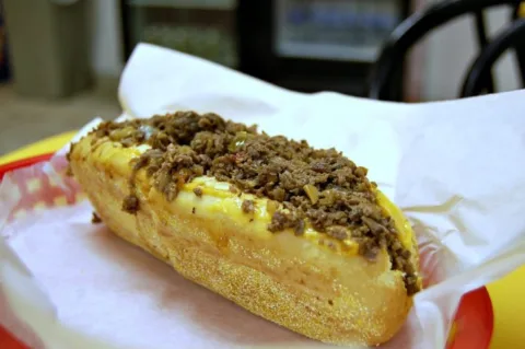 A cheesesteak sandwich on a hoagie roll. 