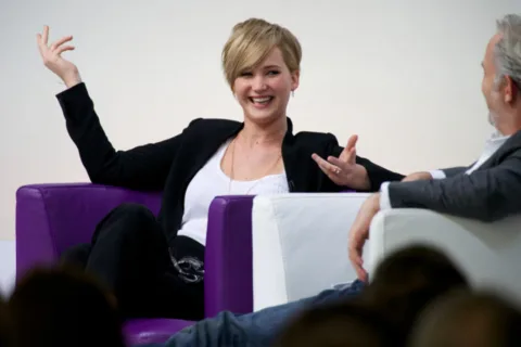 jennifer lawrence talks about how she has used a pee funnel and the Go Girl female urination device while filming movies