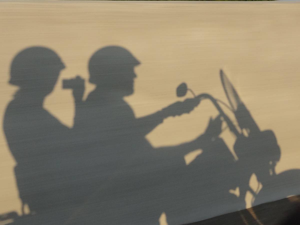 A selfie in motion that I took from the back of our motorcycle.