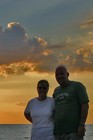 Lynnette and Jim enjoying a bright orange sunset over Lake Michiagan.