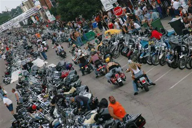 Motorcycles parked and riding down Main Street Sturgis.