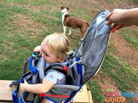 The sun shade on the Osprey baby carrier is integrated right into the pack, and it's collapsible - which means it can be opened or closed quickly!
