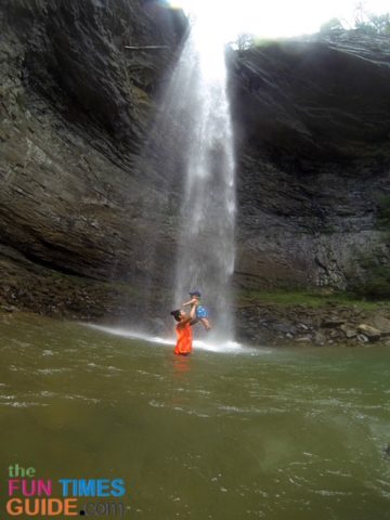 Playing underneath the waterfall at Ozone Falls while standing in the swimming hole. photo by Candida at TheFunTimesGuide.com Playing underneath the waterfall at Ozone Falls while standing in the swimming hole.