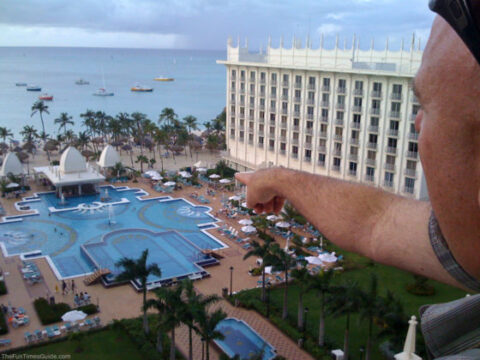 Jim pointing toward the pool at the RIU Palace Hotel and Resort - our favorite place to stay for Aruba all inclusive vacations.