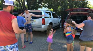 Last-minute sunscreen application in the parking lot before river tubing.