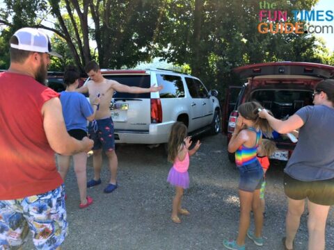 Last-minute sunscreen application in the parking lot before river tubing. photo by Candida at TheFunTimesGuide.com Last-minute sunscreen application in the parking lot before river tubing.
