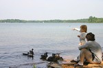 Sophie feeding the ducks while Erin watches.