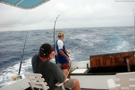 Terry reeling in the huge Wahoo fish he caught on vacation in Aruba