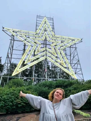 My wife standing before the illuminated Roanoke Star on Mill Mountain. 