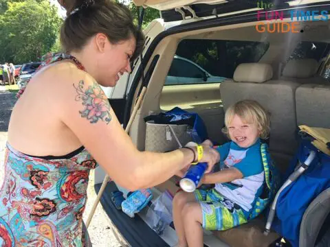 Applying sunscreen at the car before starting our float down the river with River Rat Tubing.